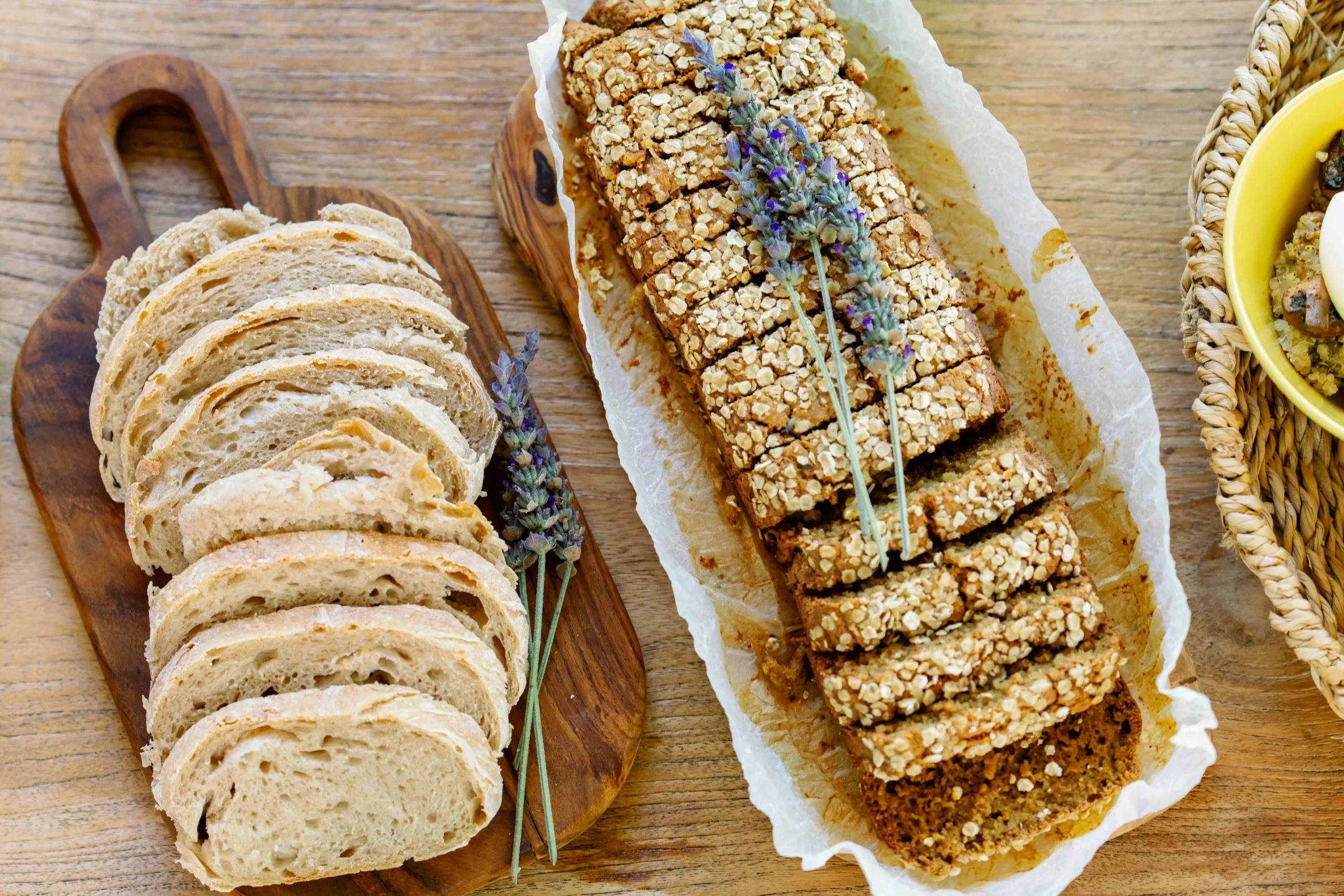 Gallery, Slices of freshly baked, artisanal plant-based bread or savory loaf served on a rustic wooden cutting board at the Seeds of Silence wellness retreat in Algarve, Portugal.