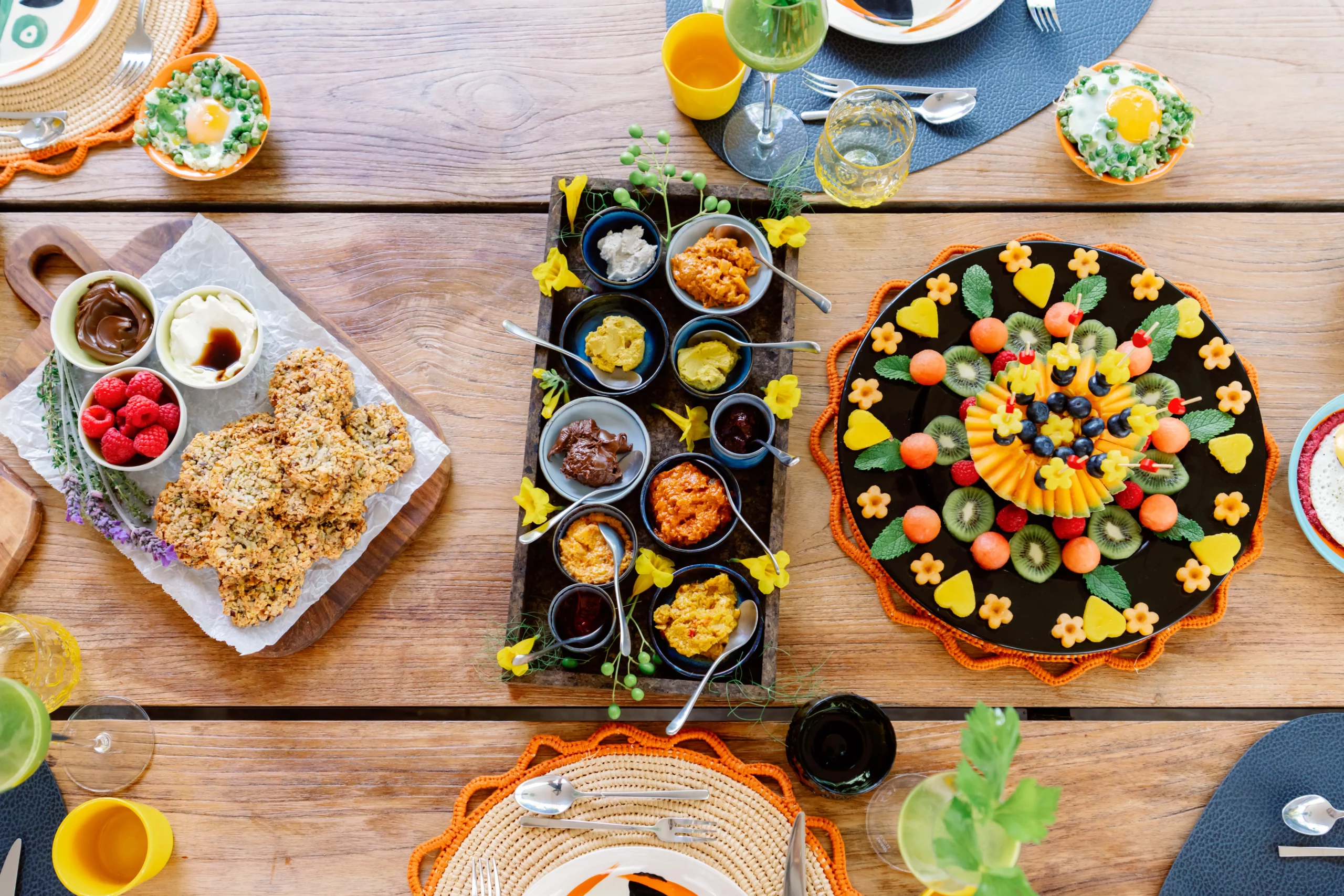 Gallery, A top-down view of three vibrant platters featuring healthy dips, fresh vegetables, berries, and plant-based spreads at the Seeds of Silence wellness retreat in Algarve, Portugal.